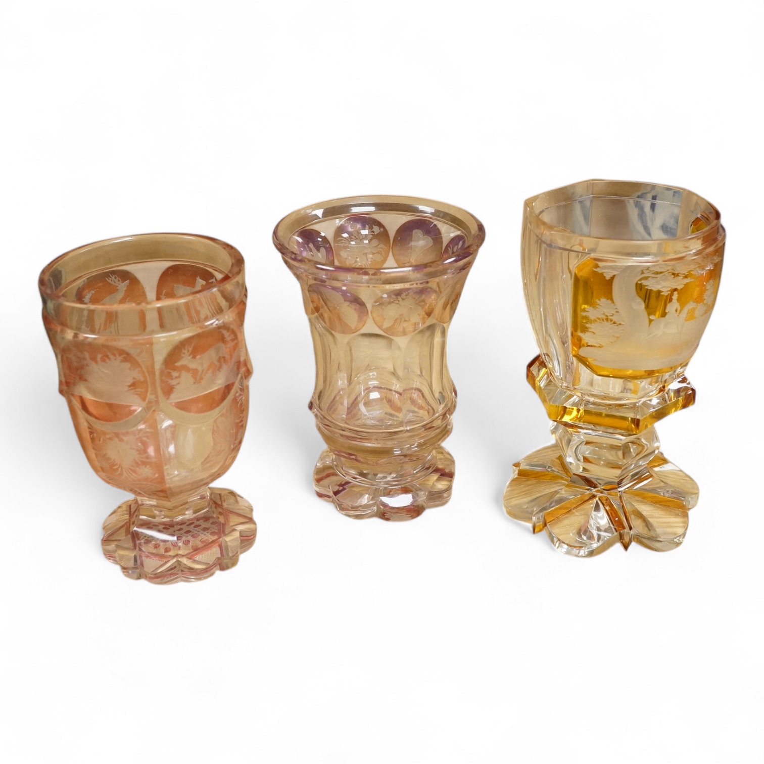 Three Bohemian colour flashed glass goblets, late 19th century, two with hunting subjects, the third decorated with insects, birds and flowers